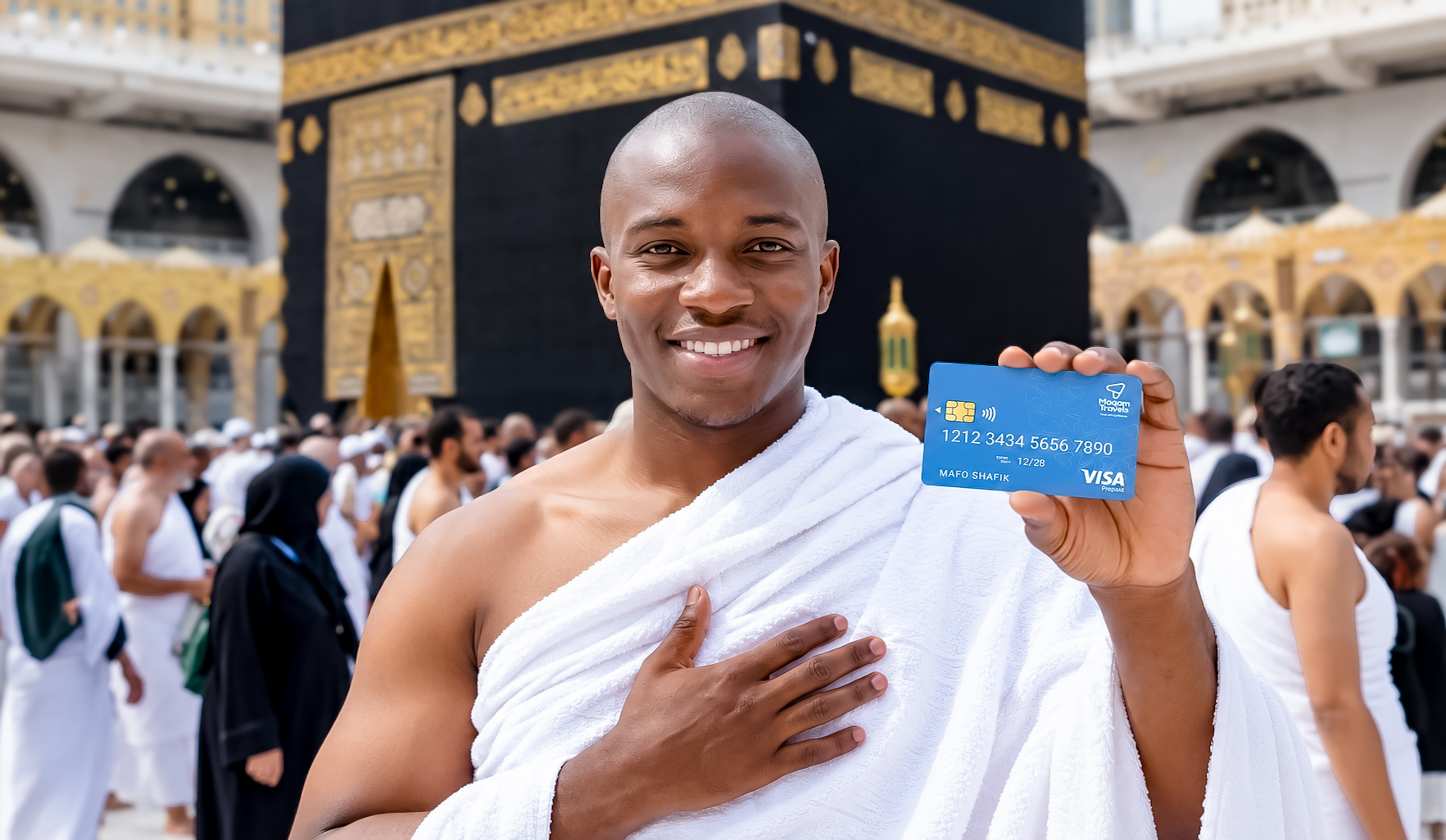 A pilgrim holding a Maqam Visa Prepaid Card in front of the Kaaba