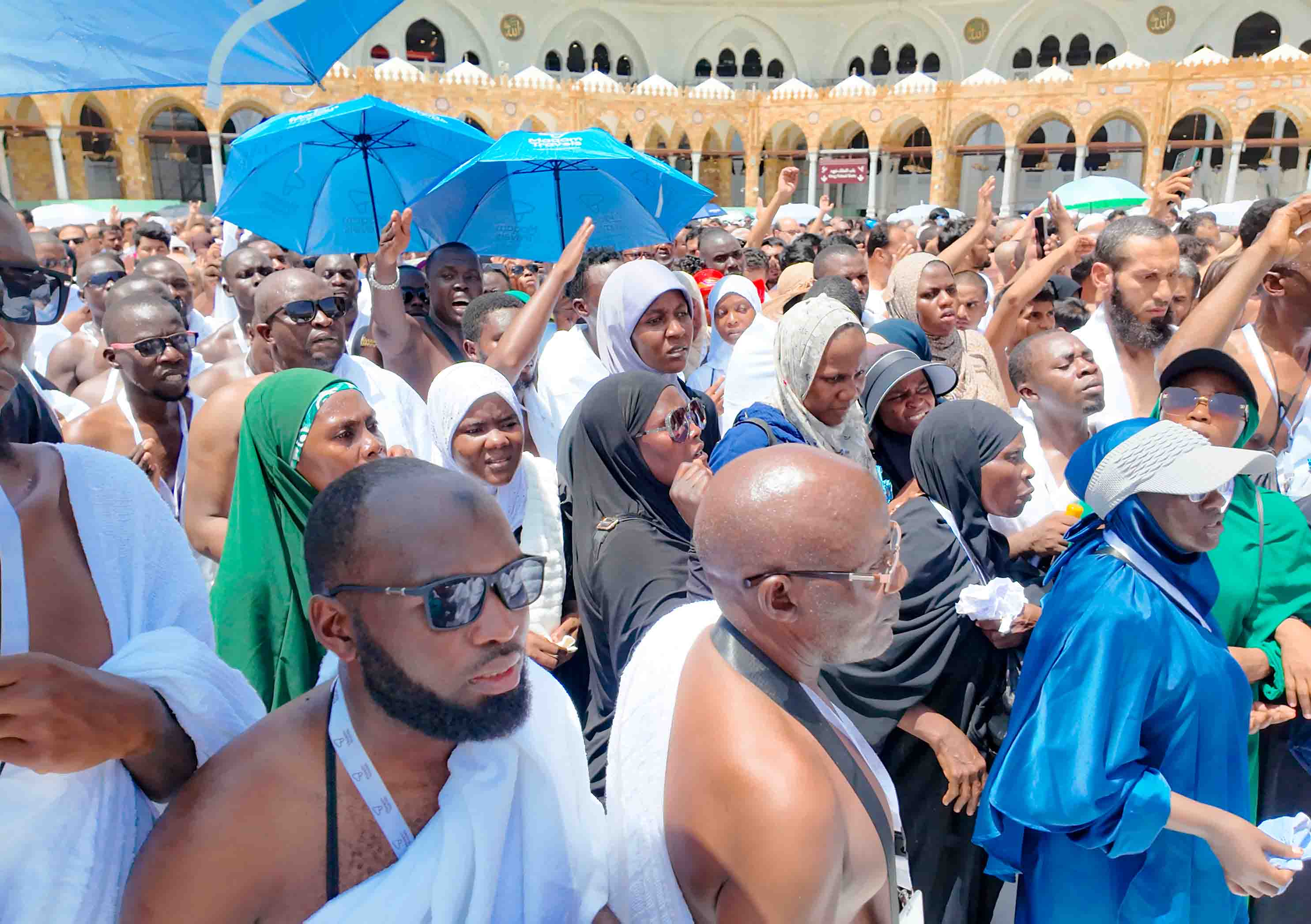 Maqam Travels pilgrims gathered near the Holy Mosque